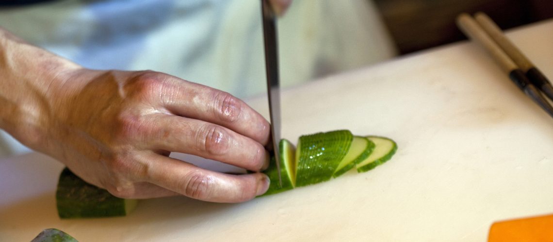 Chef cutting vegetable in the kitchen of a restaurant